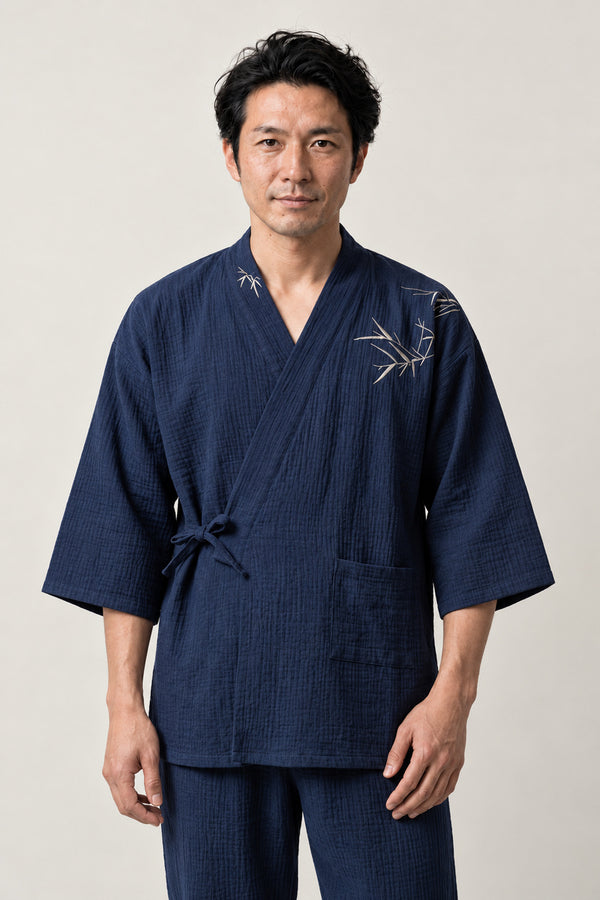 Men's Bamboo Embroidered Jinbei 'Chikurin' – navy men's jinbei with bamboo embroidery on the chest, two-piece Japanese jinbei set with side-tie top and shorts, front view on model