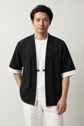 Men's Contrast Trim Kimono Jacket 'Fuchidori' – black men's kimono jacket with white contrast trim and toggle, Japanese noragi haori style cardigan, front view on model