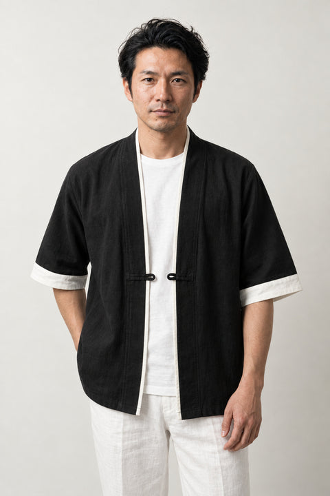 Men's Contrast Trim Kimono Jacket 'Fuchidori' – black men's kimono jacket with white contrast trim and toggle, Japanese noragi haori style cardigan, front view on model