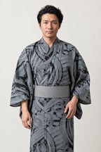 Men's Ink Wash Kimono 'Bokuseki' – grey men's kimono with black ink wash brushstroke print and grey obi, Japanese yukata robe, front view on model