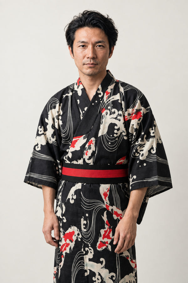 Men's Koi Carp Yukata 'Kohaku' – black men's yukata with red and white koi carp and wave print and red obi belt, Japanese kimono robe, front view on model