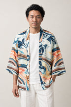 Men's Marbled Wave Kimono Jacket 'Uzushio' – cream men's kimono jacket with blue and orange marbled wave print, Japanese haori style cardigan, front view on model
