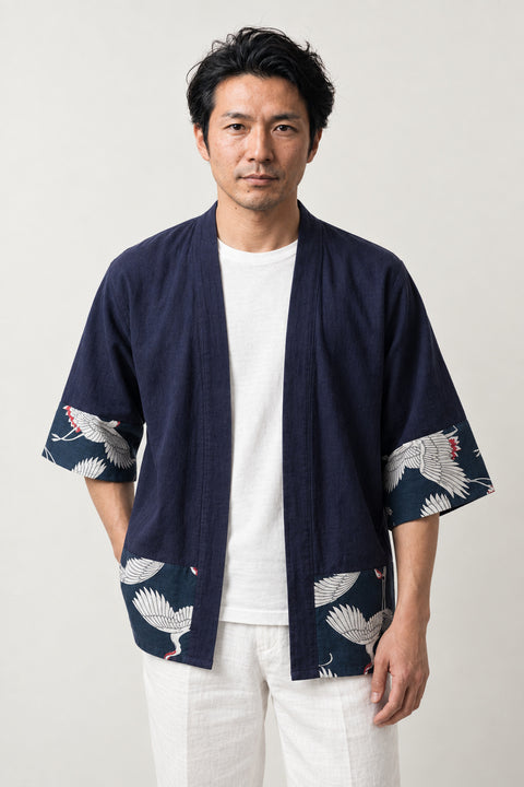 Men's Navy Crane Border Cardigan 'Tsurumai' – navy men's kimono cardigan with white crane print border on hem and cuffs, Japanese haori style jacket, front view on model