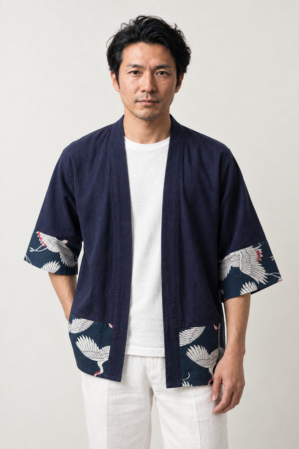 Men's Navy Crane Border Cardigan 'Tsurumai' – navy men's kimono cardigan with white crane print border on hem and cuffs, Japanese haori style jacket, front view on model