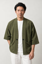 Men's Olive Utility Kimono Jacket 'Uguisu' – olive green men's utility kimono jacket with patch pockets and toggle, Japanese noragi style cardigan, front view on model