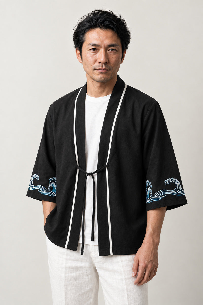 Men's Wave Trim Kimono Jacket 'Aranami' – black men's kimono jacket with white trim, front tie and wave print sleeves, Japanese haori style cardigan, front view on model