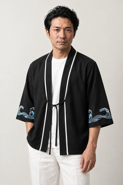 Men's Wave Trim Kimono Jacket 'Aranami' – black men's kimono jacket with white trim, front tie and wave print sleeves, Japanese haori style cardigan, front view on model