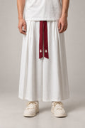Men's White Pleated Hakama 'Hyotan' – white pleated hakama with red front ties, traditional Japanese samurai style wide trousers for men, front view on model