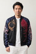 Moon and Blossom Sukajan 'Mikazuki' – black and navy sukajan with embroidered crescent moon and cherry blossom, Japanese sukajan souvenir bomber jacket, front view on model