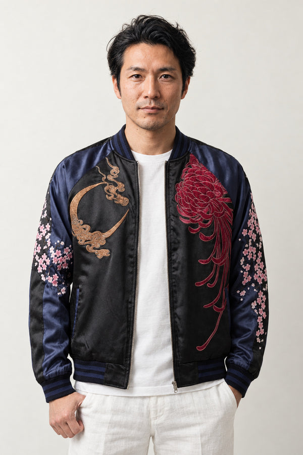 Moon and Blossom Sukajan 'Mikazuki' – black and navy sukajan with embroidered crescent moon and cherry blossom, Japanese sukajan souvenir bomber jacket, front view on model