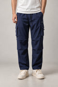 Navy Baggy Cargo Trousers 'Yuttari' – navy baggy cargo trousers with side pockets and drawstring, Japanese streetwear trousers, front view on model