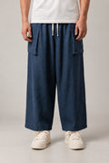 Navy Cargo Hakama Pants 'Nando' – navy wide leg cargo hakama pants with drawstring waist and side pockets, Japanese samurai style trousers, unisex, front view on model