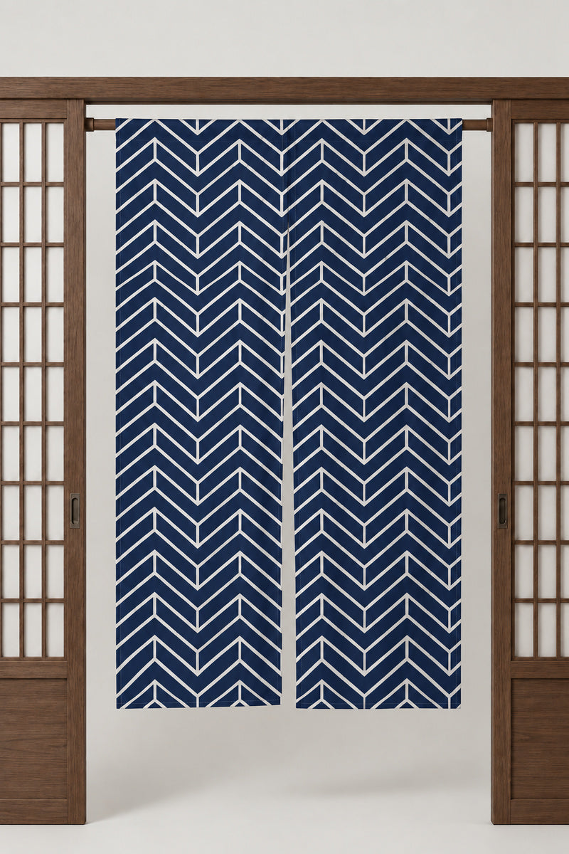 Navy Chevron Noren 'Yamagata' – navy noren with white chevron pattern, split Japanese noren door curtain hung on a rod between sliding screens, studio view