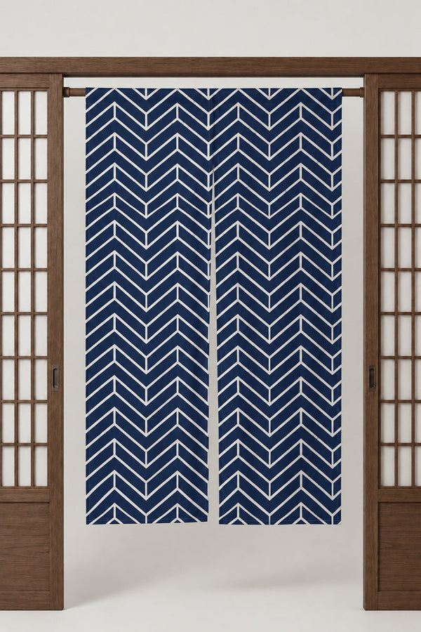 Navy Chevron Noren 'Yamagata' – navy noren with white chevron pattern, split Japanese noren door curtain hung on a rod between sliding screens, studio view