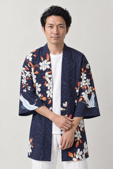 Navy Crane Festival Coat 'Akebono' – navy happi festival coat with white cranes, cherry blossom and red sun print, Japanese happi coat, unisex festival jacket, front view on model