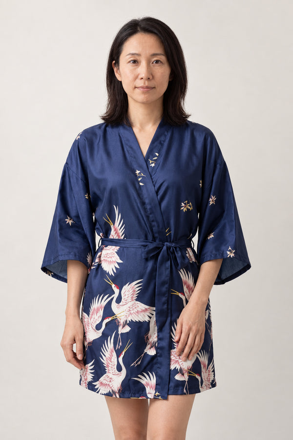 Navy Crane Short Kimono Robe 'Sorazuru' – navy women's short satin-look kimono robe with pink crane print and tie belt, Japanese dressing gown, front view on model