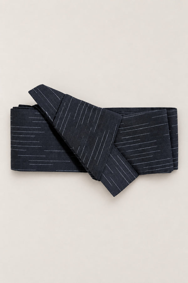 Navy Fabric Obi Belt 'Hoshikage' – navy obi belt with broken white streaks, narrow pre-tied Japanese obi belt with sewn knot and hidden adjustable closure, for kimono, yukata or jinbei, studio view