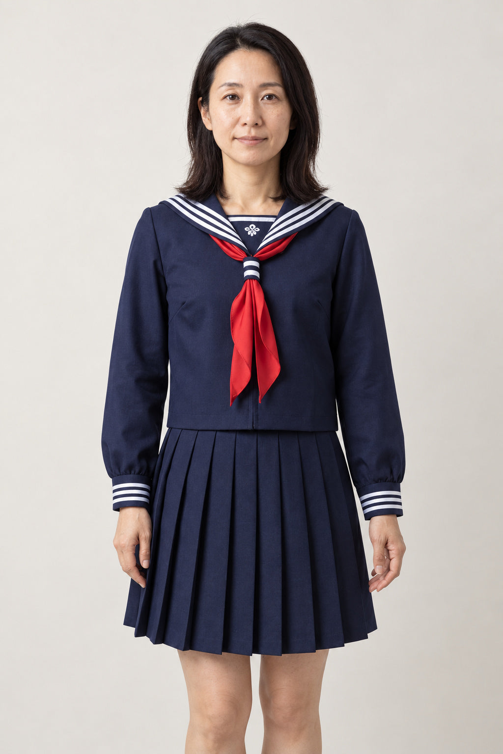Navy Japanese Sailor Uniform 'Hanakon' – navy long sleeve sailor top with white trim, red scarf tie and navy pleated skirt, Japanese school uniform seifuku set, sailor top and pleated skirt, front view on model