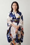 Navy Ukiyo-e Kimono 'Yofuke' – navy and white women's kimono robe with ukiyo-e geisha and pagoda print and red obi, long Japanese kimono dress, front view on model
