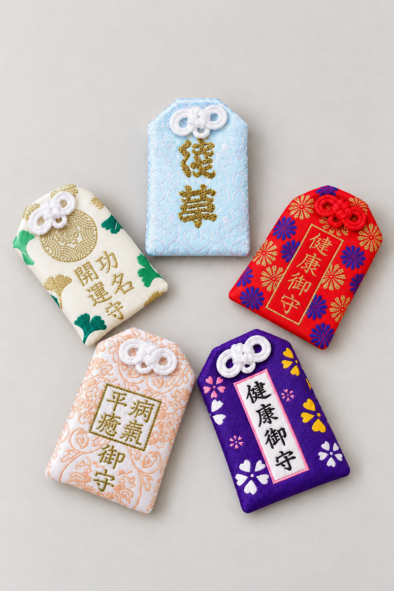 Omamori – set of five brocade omamori amulet pouches in purple, blue, red, white and pink, Japanese lucky charms, studio view