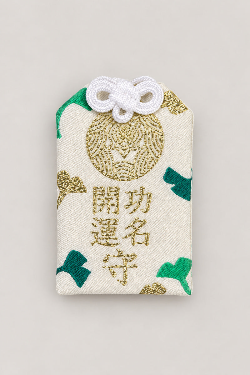 Omamori – white and green brocade omamori amulet with kanji for success and luck, Japanese lucky charm, studio view