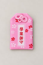 Omamori – pink brocade omamori amulet with kanji for academic success, Japanese lucky charm, studio view