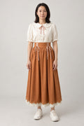 Persimmon Ribbon Blouse Set 'Kakiiro' – cream ribbon collar blouse and persimmon orange lace-up midi skirt, Japanese style two-piece outfit, front view on model