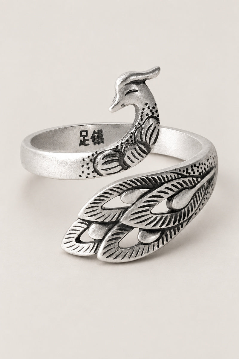 Phoenix Ring 'Hane' – open sterling silver phoenix ring with engraved tail feathers curling round the finger, adjustable Japanese phoenix ring, studio view