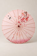 Pink Sakura Japanese Umbrella 'Sakurairo' – pink parasol printed with cherry blossom branches and falling petals, Japanese wagasa parasol with wooden frame and paper-effect canopy, open, studio view