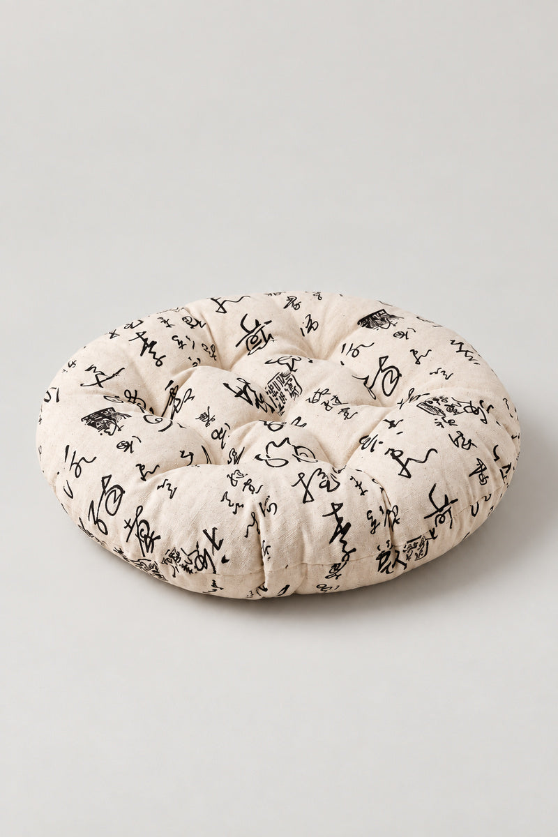 Printed Japanese Zabuton 'Garaza' – cream tufted round floor cushion with brushed calligraphy print, Japanese zabuton floor cushion, studio view
