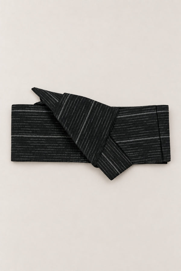 Rain Streak Obi Wrap Belt 'Harusame' – black obi belt with grey rain streak pattern, narrow pre-tied Japanese obi belt with sewn knot and hidden adjustable closure, for kimono, yukata or jinbei, studio view