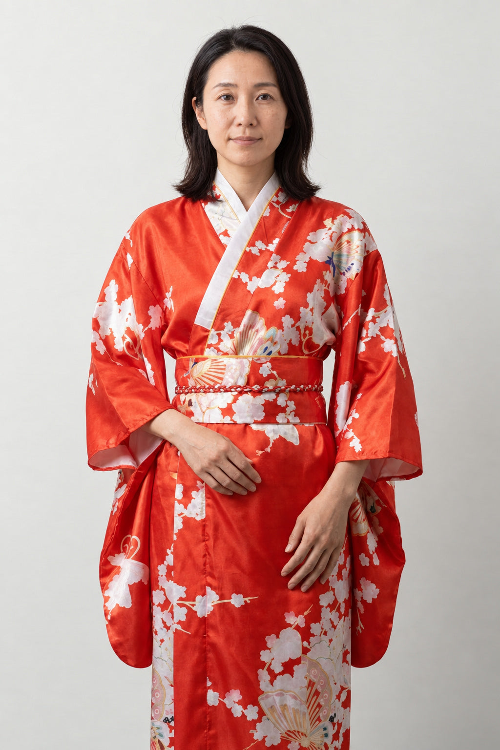 Red Fan Print Kimono Dress 'Suehiro' – bright red women's kimono dress with folding fan and cherry blossom print and obi sash, long Japanese satin-look kimono, front view on model