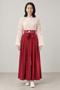 Red Hakama Style Two-Piece 'Suou' – cream embroidered kimono top and red hakama style pleated skirt with sash, Japanese two-piece outfit, front view on model