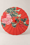 Red Japanese Umbrella 'Benigasa' – red parasol printed with pink peonies and green leaves, Japanese wagasa parasol with wooden frame and paper-effect canopy, open, studio view