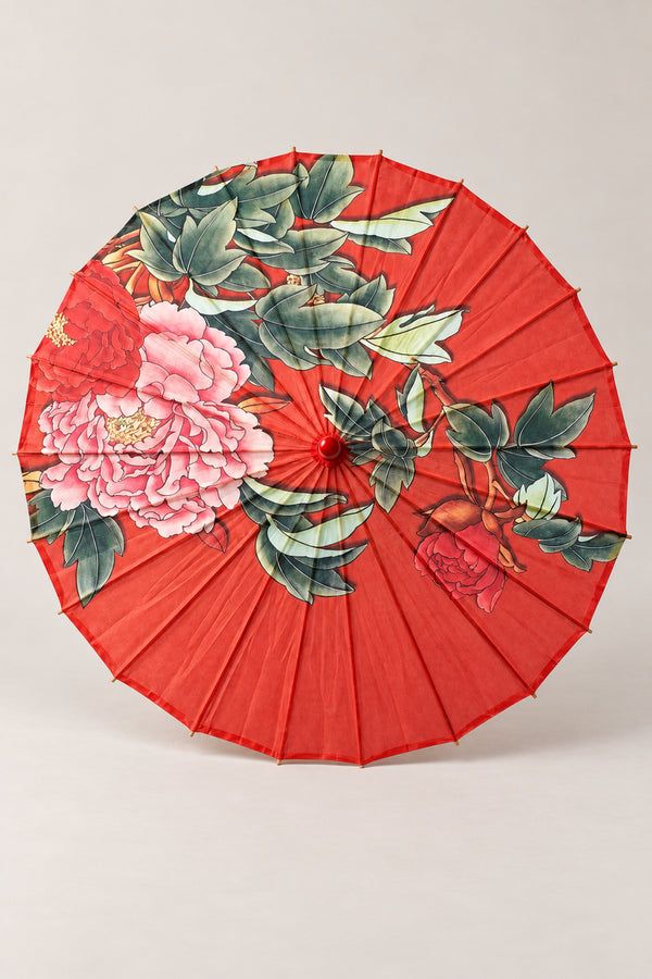 Red Japanese Umbrella 'Benigasa' – red parasol printed with pink peonies and green leaves, Japanese wagasa parasol with wooden frame and paper-effect canopy, open, studio view