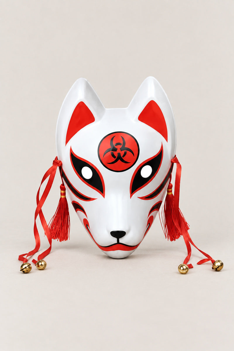 Red Kitsune Mask 'Inari' – white kitsune fox mask with red markings, red disc crest on the brow, red tassels and bells, Japanese kitsune festival mask, studio view
