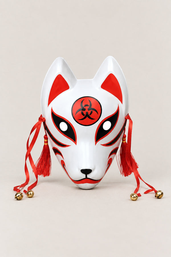 Red Kitsune Mask 'Inari' – white kitsune fox mask with red markings, red disc crest on the brow, red tassels and bells, Japanese kitsune festival mask, studio view