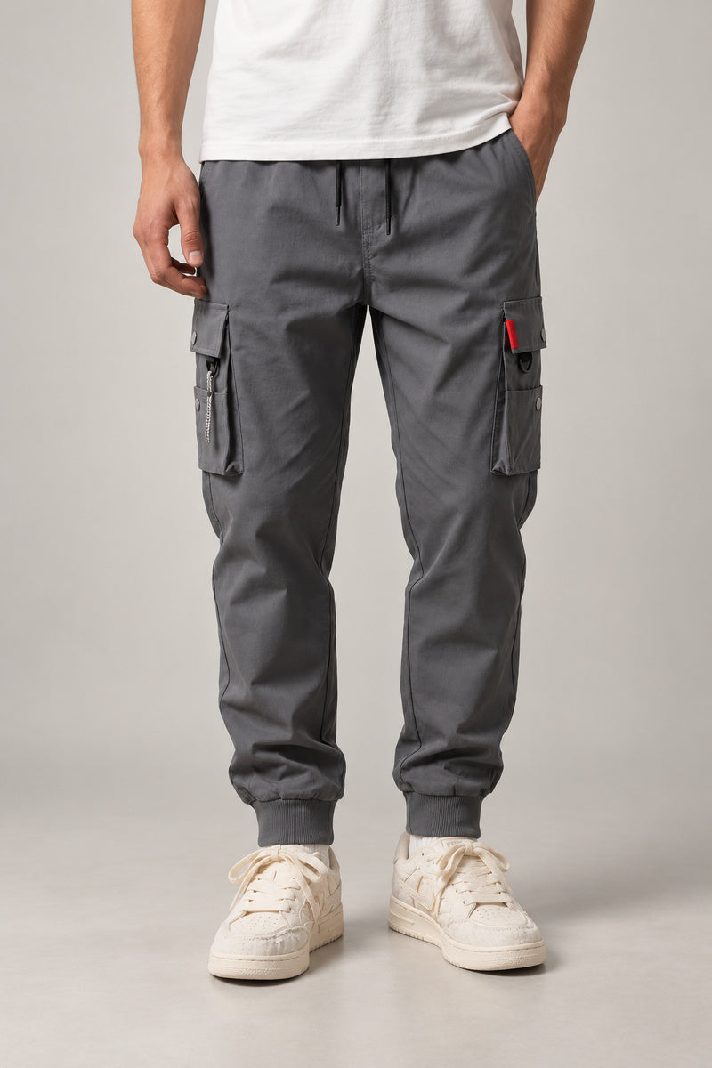 Red Seam Cargo Joggers 'Hitosuji' – grey cargo joggers with red seam detail and cuffed hem, Japanese streetwear trousers, front view on model