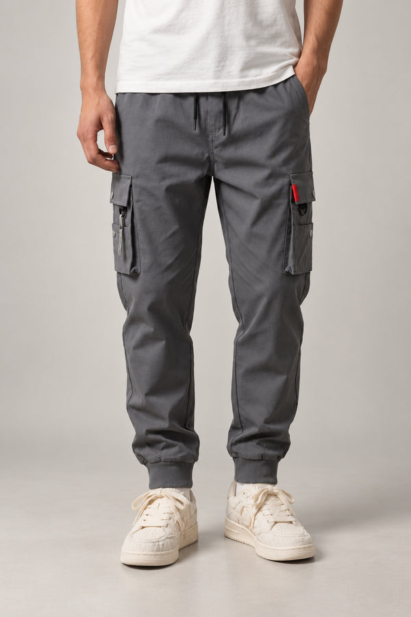 Red Seam Cargo Joggers 'Hitosuji' – grey cargo joggers with red seam detail and cuffed hem, Japanese streetwear trousers, front view on model