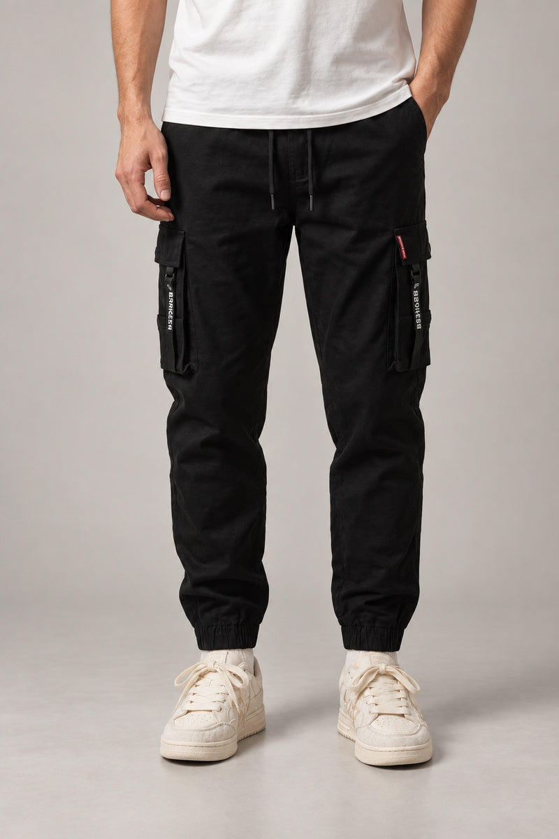 Red Seam Cargo Joggers 'Hitosuji' – black red seam cargo joggers with side pockets, front view on model