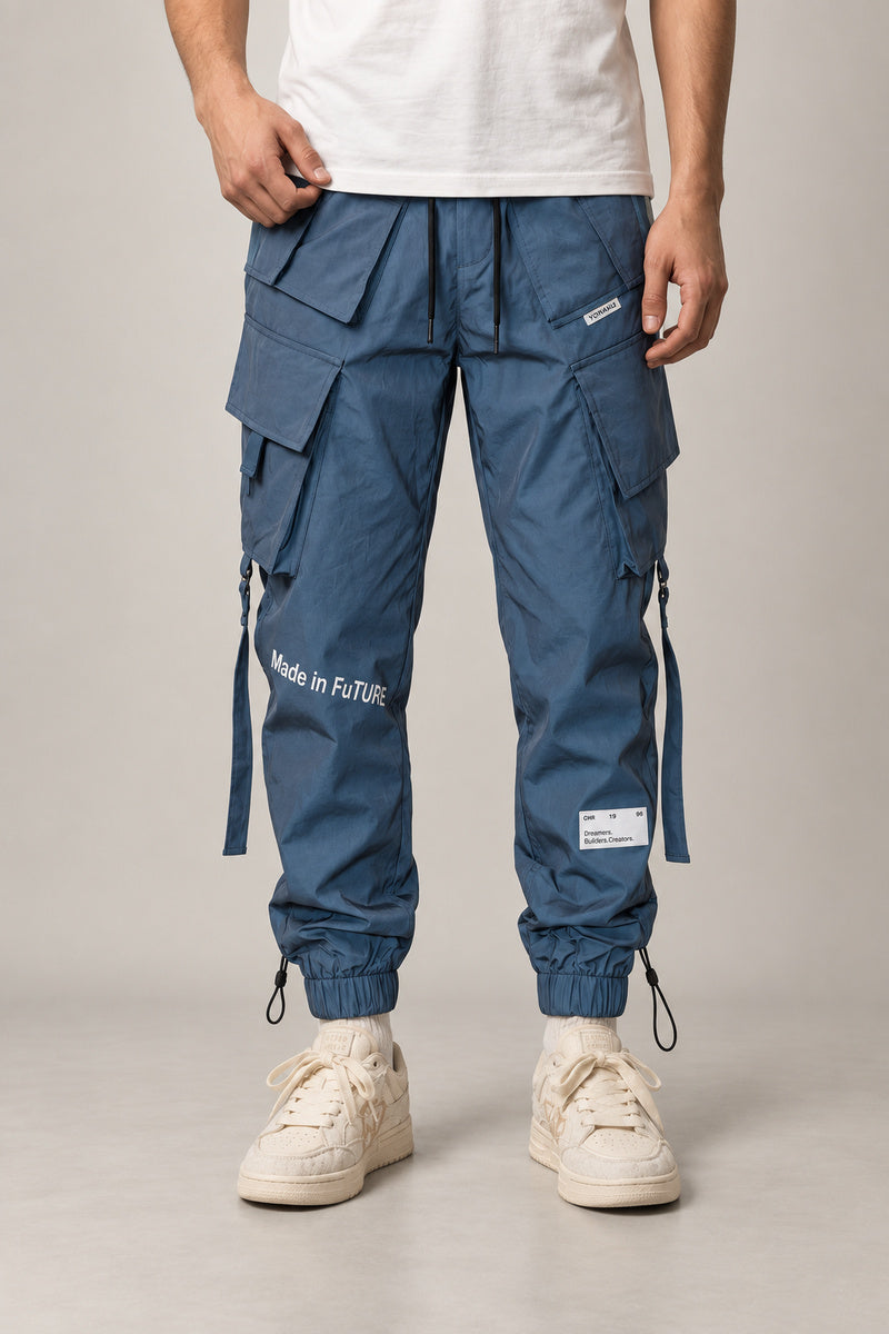 Reflective Techwear Pants 'Yakou' – steel blue techwear cargo pants with reflective straps and multiple pockets, Japanese streetwear joggers, front view on model