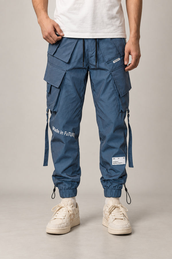 Reflective Techwear Pants 'Yakou' – steel blue techwear cargo pants with reflective straps and multiple pockets, Japanese streetwear joggers, front view on model