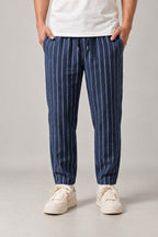 Relaxed Pinstripe Trousers 'Hosojima' – navy pinstripe relaxed trousers, front view on model