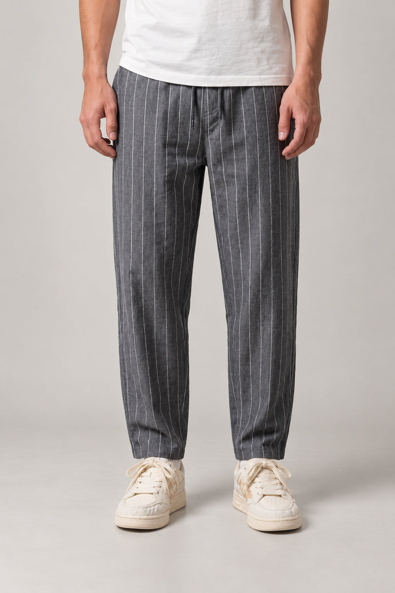 Relaxed Pinstripe Trousers 'Hosojima' – grey pinstripe relaxed trousers with cuffed hem, front view on model