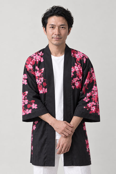 Rising Koi Matsuri Coat 'Toryumon' – black happi matsuri coat with pink cherry blossom sleeves and koi print, Japanese happi coat, unisex festival jacket, front view on model