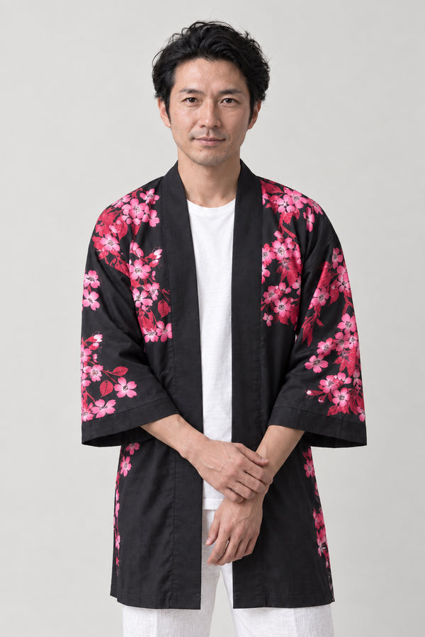 Rising Koi Matsuri Coat 'Toryumon' – black happi matsuri coat with pink cherry blossom sleeves and koi print, Japanese happi coat, unisex festival jacket, front view on model