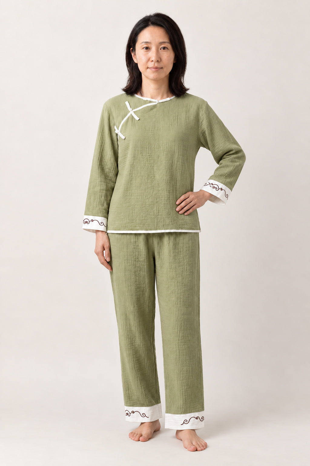 Sage Knot Button Pyjamas 'Wakaba' – sage green women's pyjama set with Chinese knot buttons, Japanese style loungewear top and trousers, front view on model