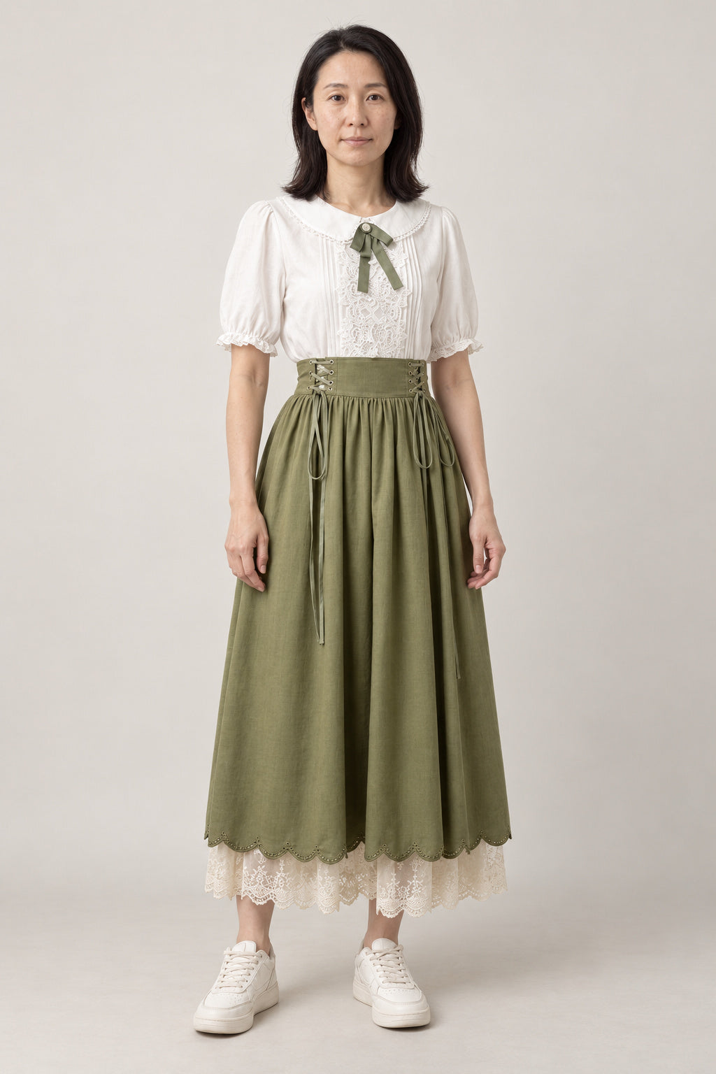 Sage Mori Girl Skirt Set 'Kokeiro' – white puff sleeve blouse with ribbon and sage green high-waist skirt with lace hem, mori girl Japanese style outfit, front view on model
