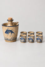 Sake Set 'Tokkuri' – sake flask standing in its warming jar with six matching cups, blue carp stoneware, studio view