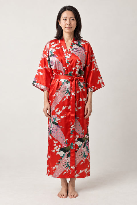 Scarlet Peacock Bathrobe 'Akashou' – scarlet red women's long satin-look kimono bathrobe with peacock and blossom print, Japanese robe, front view on model